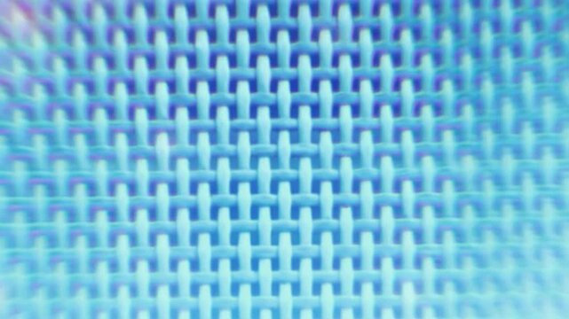 Close-up view of a woven blue fabric with a repeating pattern of interlocking threads.