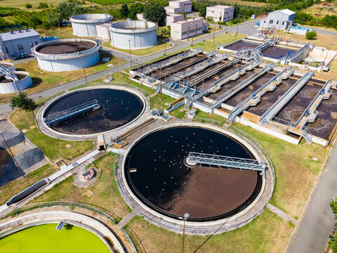 Water treatment facility in operation with tanks and equipment visible from above during daylight hours