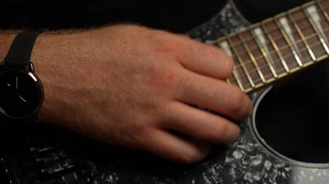Young guy with ginger beard playing electrical guitar. Strumming and tapping and string picking.