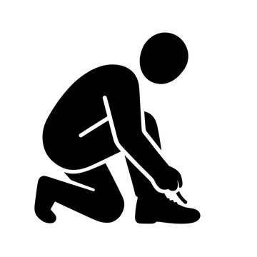 Person Kneeling To Tie A Shoelace