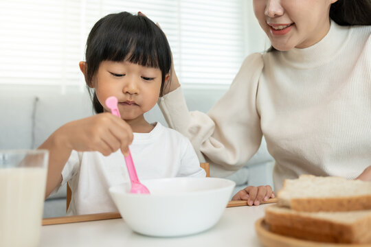 activities together during the holidays. mother and daughter are having a meal together, Mother prepare breakfast for daughter on morning, enjoy, weekend, vacant, family time, mother day