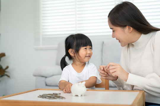 Child happy lean Save money. Mother teaching daughter for saving. wealth, Finance, insurance, investment, education, future, plan life, banking, family, health, health and accident insurance.