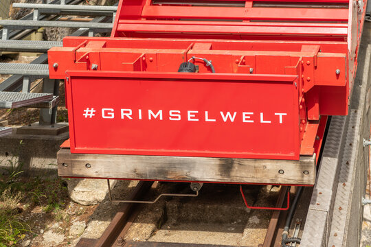 07 July 2026, Guttannen, Switzerland. Red Gelmerbahn funicular carriage at the Gelmerbahn station with Grimselwelt branding in the Swiss Alps