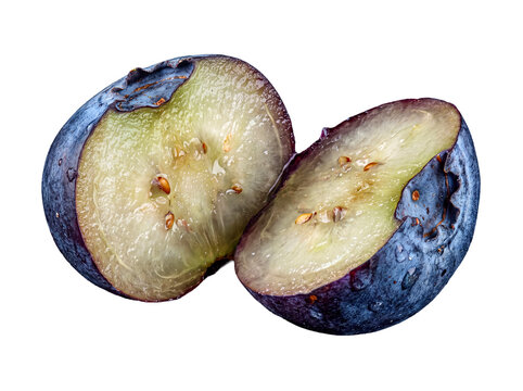 Two fresh blueberry halves with water droplets, separated, showing juicy pulp and seeds.