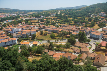 Fototapeta premium High angle panoramic view of the rural town of Montalegre in northern Portugal with traditional orange roofs and surrounding green hills. 