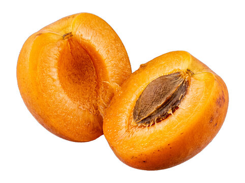 Perfectly ripe apricot fruit, sliced in half to showcase its golden-orange interior and central seed, on transparent.