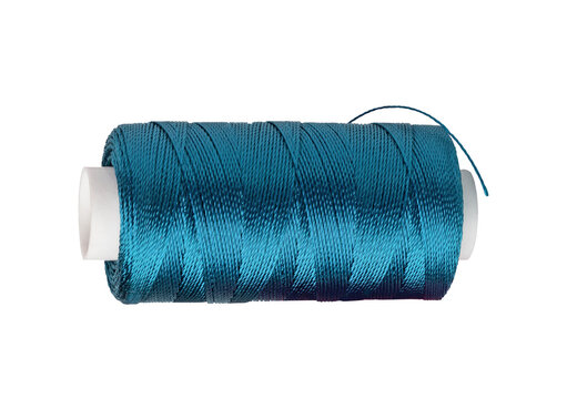 Cyan blue sewing thread on white spool for textile production.