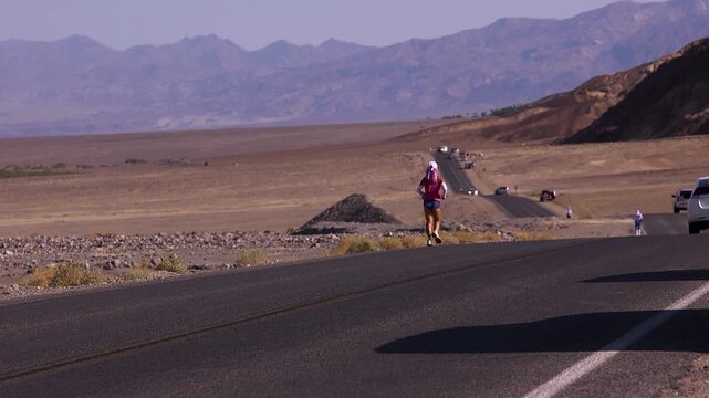 Woman running off in to the desert of death valley