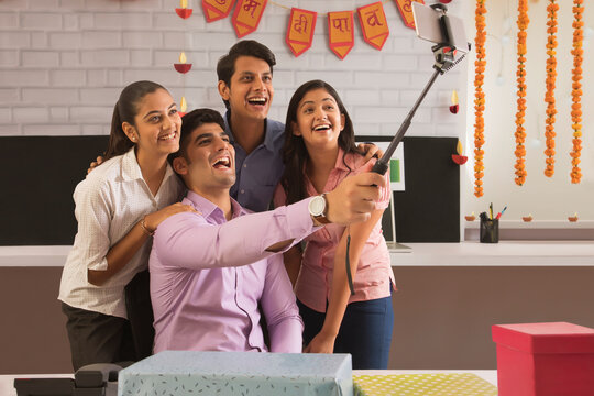 Colleagues clicking a selfie in office on the occasion of Diwali celebration 