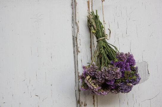 Dried statice bouquet on vintage white wooden door