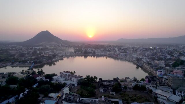 Aerial view of sacred Pushkar Lake at sunset with surrounding ghats and hills, Rajasthan, India