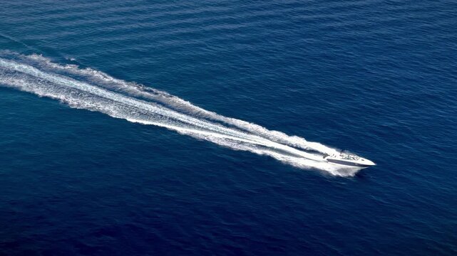 Aerial view of a motor sports boat cruising over the ocean with high speed