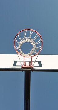 Fitness, man and dunk in net on basketball court for shooting drills, layup practice or technique. Low angle, jump and player with match training outdoor for ball control, skill development and sport