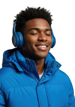 Young black man with curly hair wearing a blue puffer jacket and headphones, eyes closed and smiling against a white background. Concept of musical immersion