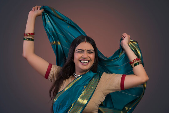 young woman dancing in saree