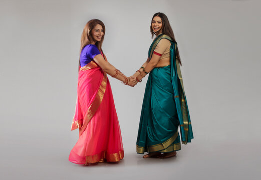 young women dancing in saree