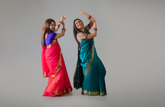 young women dancing in saree