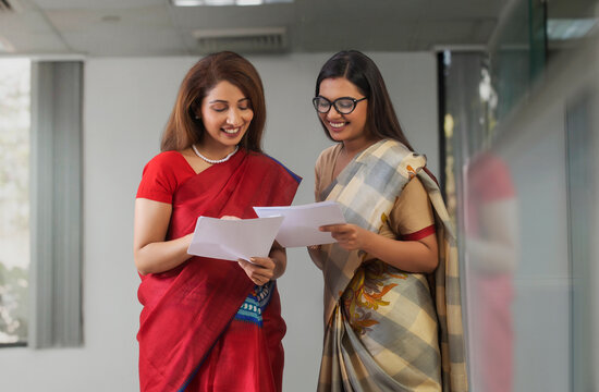 two employees analysing reports