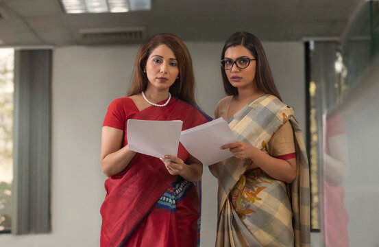 two employees analysing reports