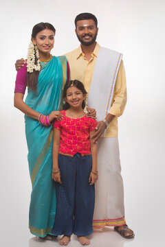 portrait of a south indian family smiling at the camera