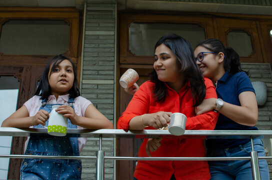 Mother and daughters enjoying coffee 