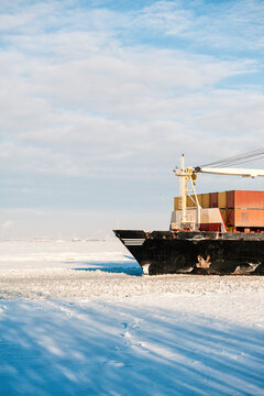 Winter shipping. Cargo ships in frozen ice sea fairway