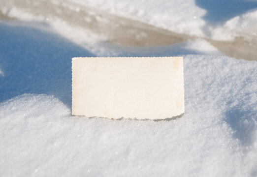 Blank vintage card offers copyspace. Snow background creates seasonal mood