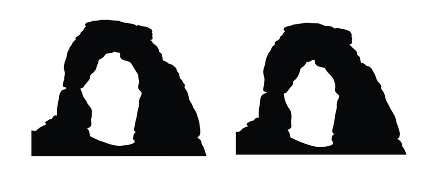 Black silhouette of delicate arch rock formation in utah desert landscape