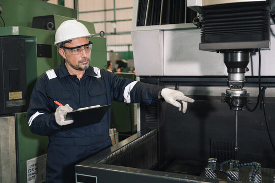 Engineer working and control machine at auto parts factory