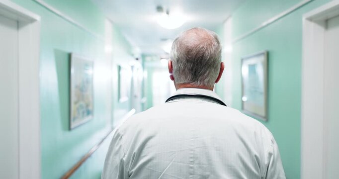 Man, doctor or walking in hospital for healthcare, schedule or appointment punctuality for care. Back, hallway or mature specialist in clinic with medical professional, consultation or service minded
