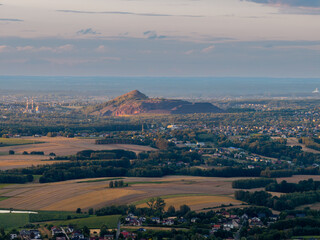 Naklejka premium Mining waste heap dominating over silesian landscape with villages and fields