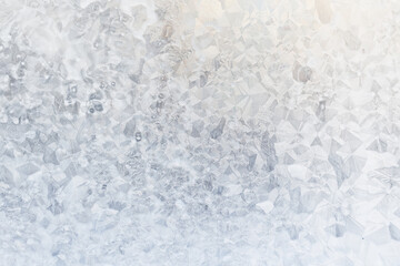 Obraz premium white winter background, frosty patterns on glass, abstract backdrop of ice and snow crystals in a blur