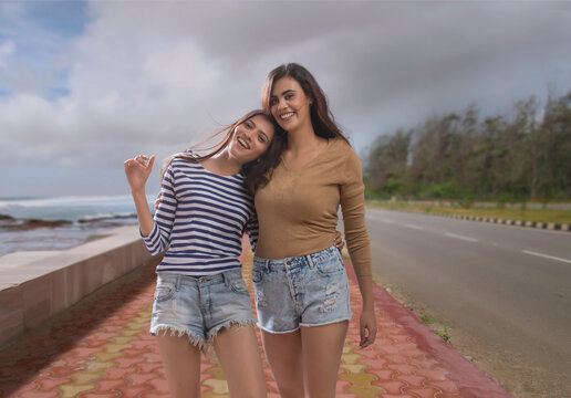 Woman standing with her friend on a footpath