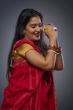 Portrait of a beautiful Bengali woman holding conch shell