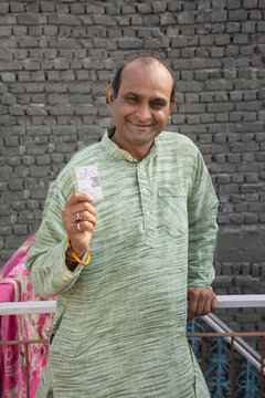 Portrait Of Indian Man Showing Voter's Card
