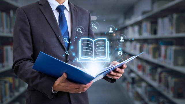 Professional Man in Suit Holding Folder with Digital Hologram of an Open Book in a Library for E-Learning and Knowledge Management