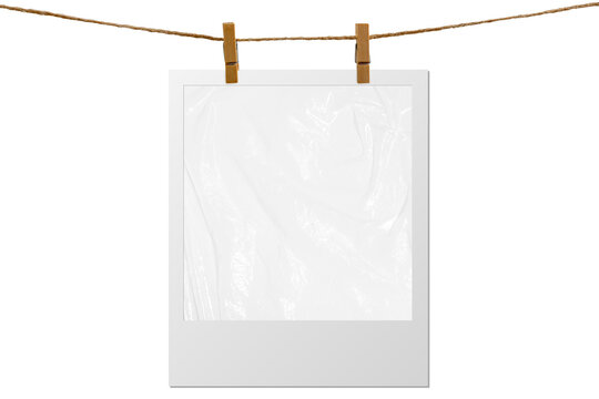 Blank photo frame hanging on a rope with a wooden clothespin. Isolated transparent PNG mockup.