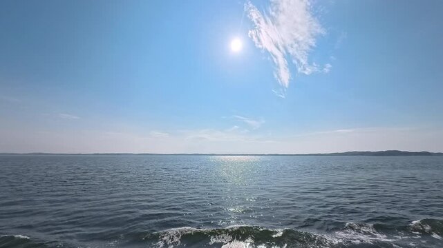 Sunny summer sky background footage with radiant sunlight and ocean waves for seasonal commercial