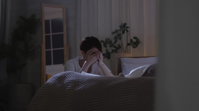 夜中に部屋で落ち込む女性