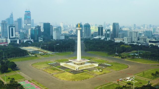 Aerial View of National Monument Monas, Merdeka Square, and Downtown Jakarta City Skyline