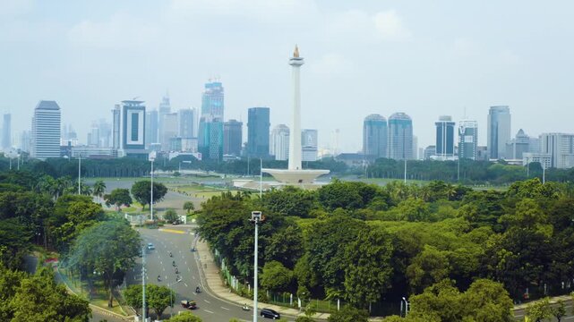 Aerial View of National Monument Monas in Jakarta City Skyline with Modern Skyscrapers