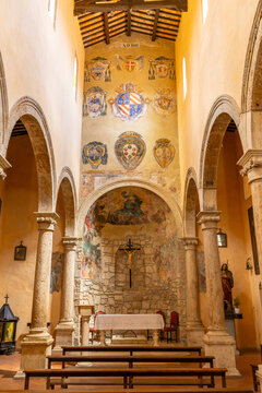 Ancient church interior with altar and many historical coats of arms