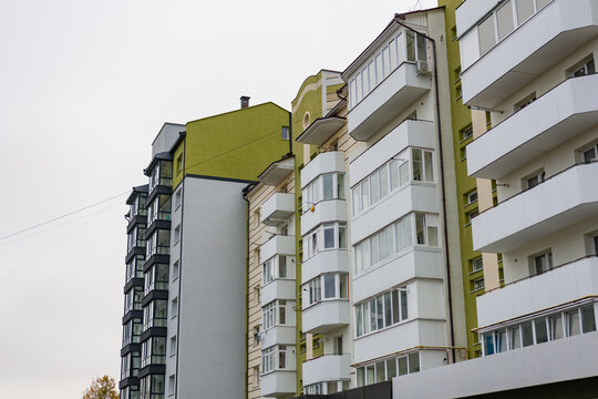 Modern residential architecture showcases vibrant colors in a quiet urban neighborhood during an overcast fall day