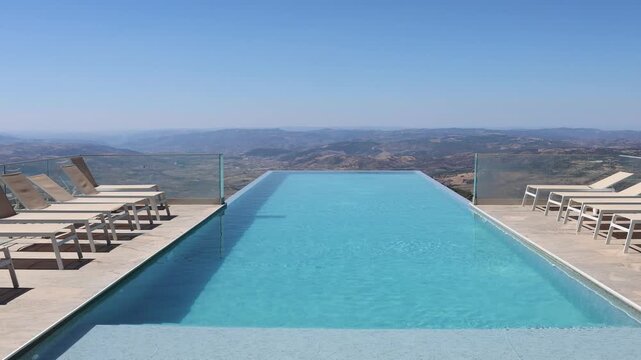 Luxury infinity pool overlooking hilly landscape