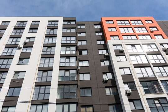 Modern apartment building showcases sleek architecture and vibrant colors, blending style and functionality in a lively urban setting