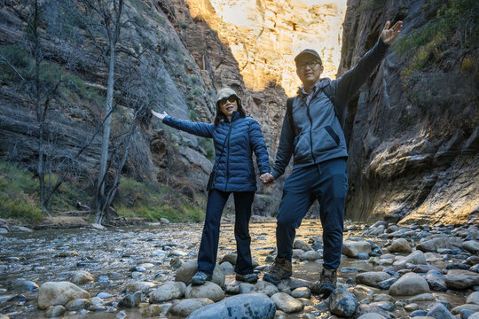 Hikers posing for a photo in Zion National Park along The Narrows trail. Utah. USA.