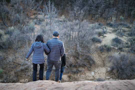 Couple hiking in the rocky terrain of Zion National Park. Utah. USA.