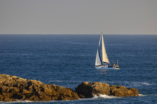 Sailboat navigating blue ocean near Saint Pabu coast