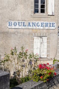 Boulangerie sign on an old building wall with flowers, La Rochebeaucourt et Argentine