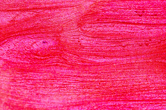 abstract background of sparkling pink nail polish texture